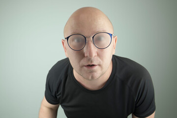 man with misted glasses looks surprised. the concept of surprise, indignation.