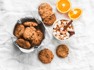 Dried cranberries, walnuts, oatmeal cookies and hot chocolate,  on a light background, top view