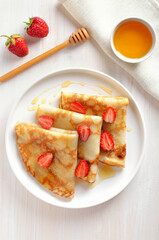 Homemade crepes with strawberry slices