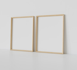 Two wooden frames leaning on white floor in interior mockup. Template of pictures framed on a wall 3D rendering