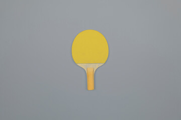 Demonstrating trendy colors of the year 2021. Grey and yellow. Table tennis racket