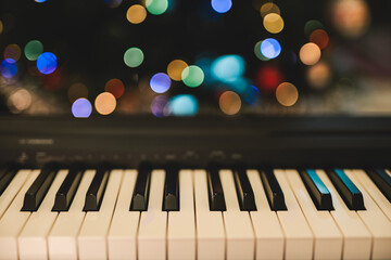Christmas illuminations and piano keyboard. Holidays, Happy New Year, Christmas concept