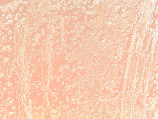Snowflakes, white snow ice, frosty patterns close-up on a beige, delicate peach background.