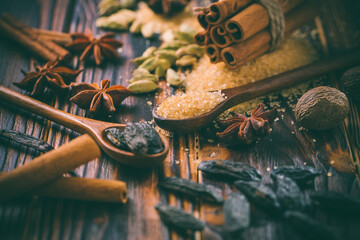 Fragrant spices for Christmas baking on wooden background