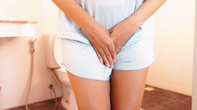 Hands woman holding her crotch,Female need to pee all the time,Urinary incontinence