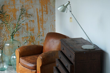 Interior design and decoration of living room decorated with leather armchair and coffee stool...