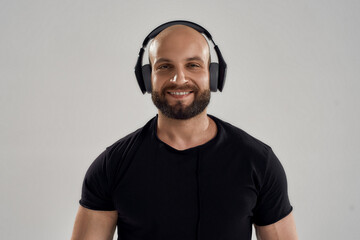 Portrait of young caucasian bodybuilder wearing headphones