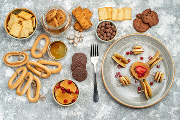 Breakfast time with stuffy pancakes cookies biscuits and honey on blue backgrounds