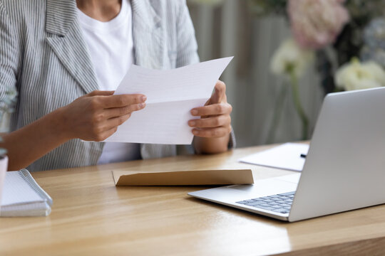 Getting News By Mail. Close Up Of Young Lady Involved In Paperwork At Home Office Studio Hold Paper Letter In Hands. Businesswoman Get Message Out Of Envelop Read Information From Bank Client Supplier