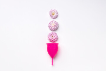 Menstrual cup with flowers on white background