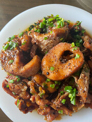 Ca kho to - Braised fish cat: Vietnamese cuisine. In a ceramic cooking pot, catfish is deeply...