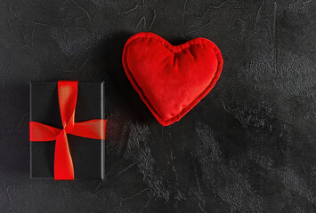 Festive composition with gift box and hearts on red background. Valentine's day concept.