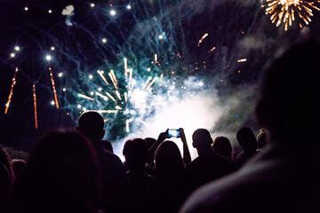 Fototapeta na wymiar New year concept - cheering crowd and fireworks