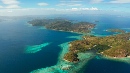 Fototapeta na wymiar aerial view tropical islands with blue lagoons, coral reef and sandy beach. Palawan, Philippines. Islands of the Malayan archipelago with turquoise lagoons.