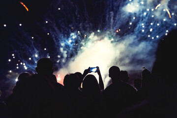 Crowd watching fireworks and celebrating new year eve