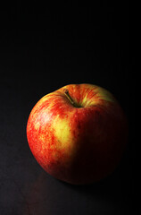 An apple against black background