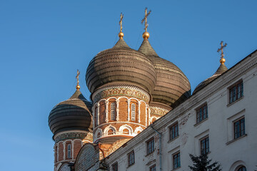 Fototapeta na wymiar Beautiful domes with crosses against the blue sunny sky. Colorful photo
