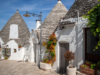  Tradtional white houses in Trulli village. Alberobello, Italy. The style of construction is...