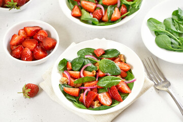 Healthy breakfast with fruit salad from strawberry, spinach and walnut