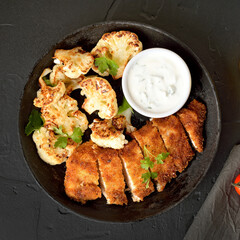 Sliced roasted chicken breast and fried cauliflower