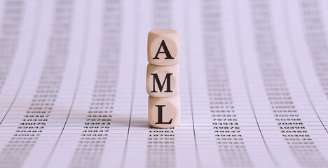 Money laundering concept, wooden word block AML on chart