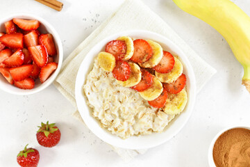 Oatmeal porridge with strawberry, banana in bowl