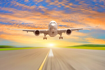 Fototapeta na wymiar Flying plane before landing on the runway evening sunset scenic beautiful sky on the background.
