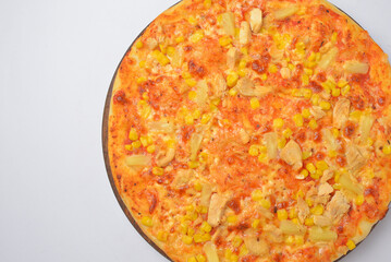 Pizza Margherita served on a round wooden board over white background.
