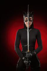 a woman in a black belt and cat mask with a katana