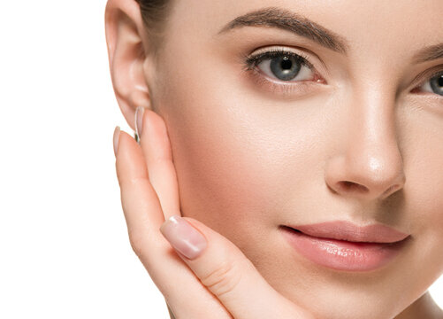 Beautiful woman face hands touching cheeks with healthy clean beauty skin close up
