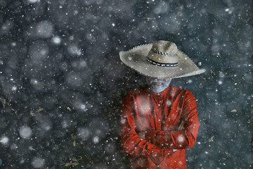 man in sombrero hat with brim, mexican style, latin america, snow cold winter christmas background