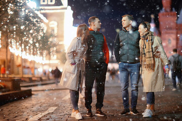 Fototapeta premium red square evening winter, a group of friends for a walk new year christmas moscow russia