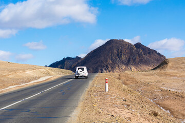 A beautiful mountain road without people and cars on a sunny day, a stunning landscape and an exciting way for car enthusiasts. The road on which you want to go forever, Mongolia