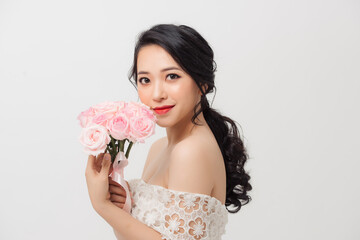 Portrait of elegant woman with flower bouquet over white background.