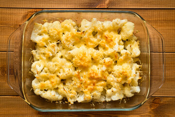 Cauliflower baked with cheese in the oven in a glass baking dish. Homemade food.