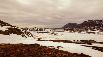 Hiking the Arctic Circle Trail in snowy mountain landscapes, a long distance trek between Kangerlussuaq and Sisimiut in Greenland.