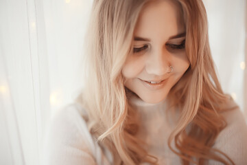 cute blonde sweater portrait / winter look, portrait of beautiful model with long hair in cold season