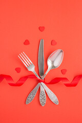 Top view of festive table setting for Valentine's day on the red background
