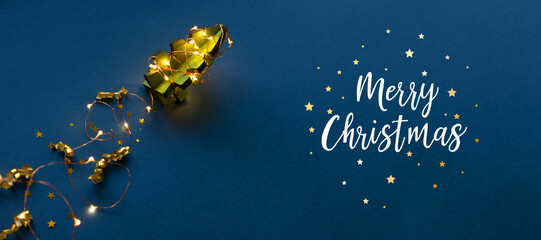 Wooden Christmas tree in the form of a rocket on a dark blue background.