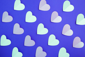 Top view of paper hearts on the blue background