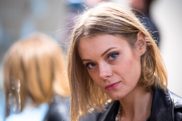 Close up portrait of a pensive and daydreaming beautiful blonde woman. Selective focus