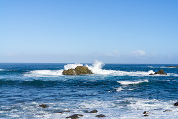 The rough Atlantic Ocean near Tenerife, Spain, strong waves break on the rocks in the water