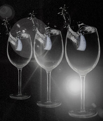 Splash in wine glass with lemon on a black stardust background