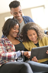 African-american family of three using digital tablet
