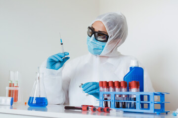 Doctor hands in gloves holding syringe and vaccine. Prevention, immunization and treatment from...