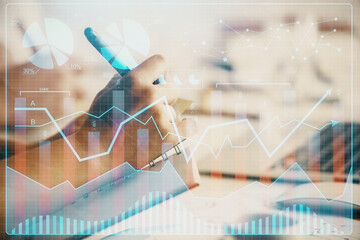 Double exposure of forex chart drawing over people taking notes background. Concept of financial...