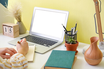 Young woman working on modern laptop in office