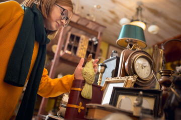 Toys. Cheerful little blonde boy looking for home decoration and holiday's gifts in household store. Stylish retro things for greetings or design. Interior renovation, celebrating time.