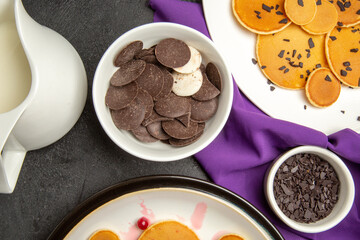 top view delicious little pancakes with cookies on the dark background milk dessert sweet