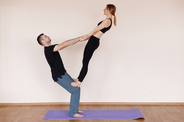 Fototapeta na wymiar Couple trains together in yoga